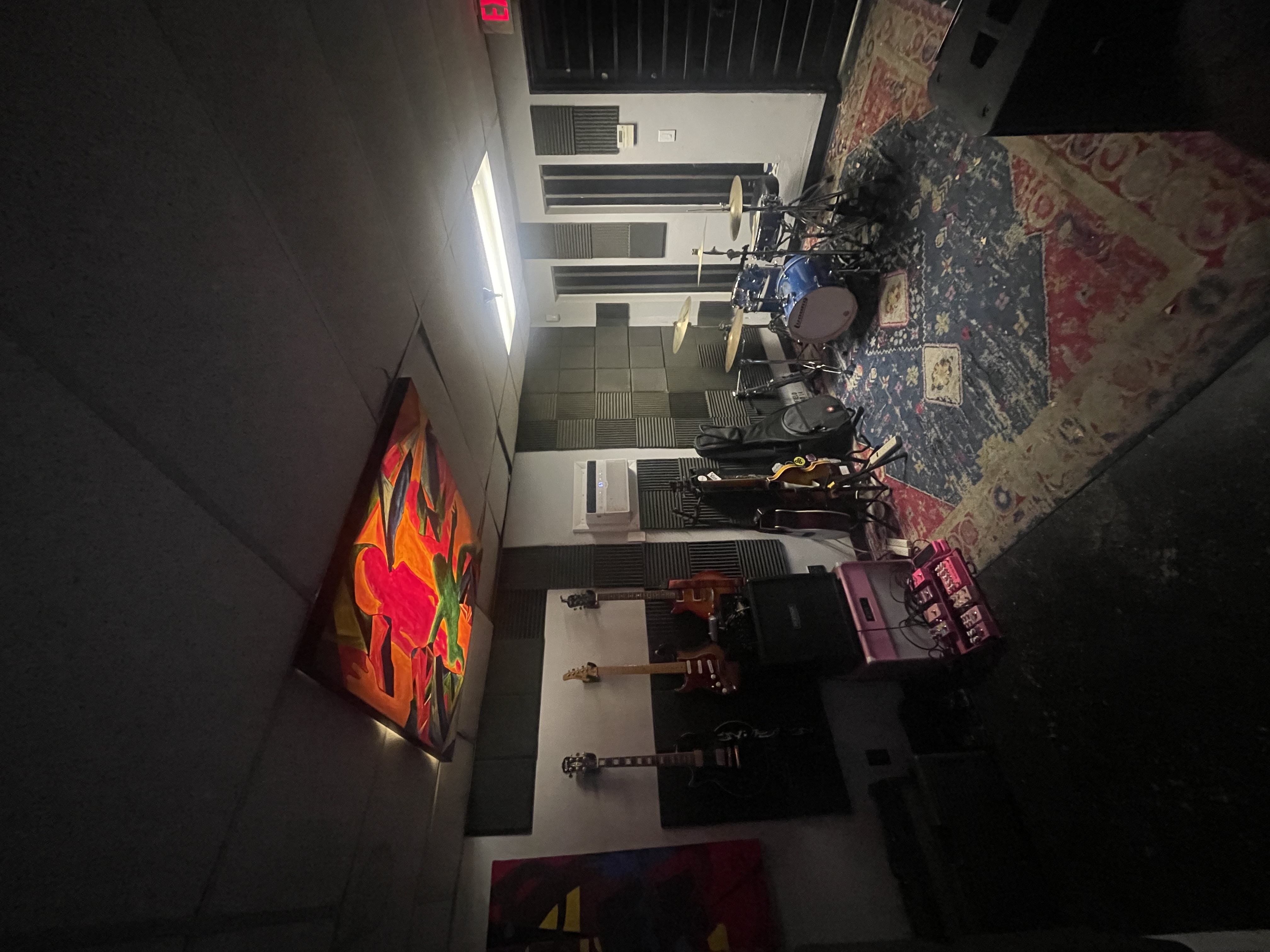 Recording studio with guitars, drum kit and acoustic panels